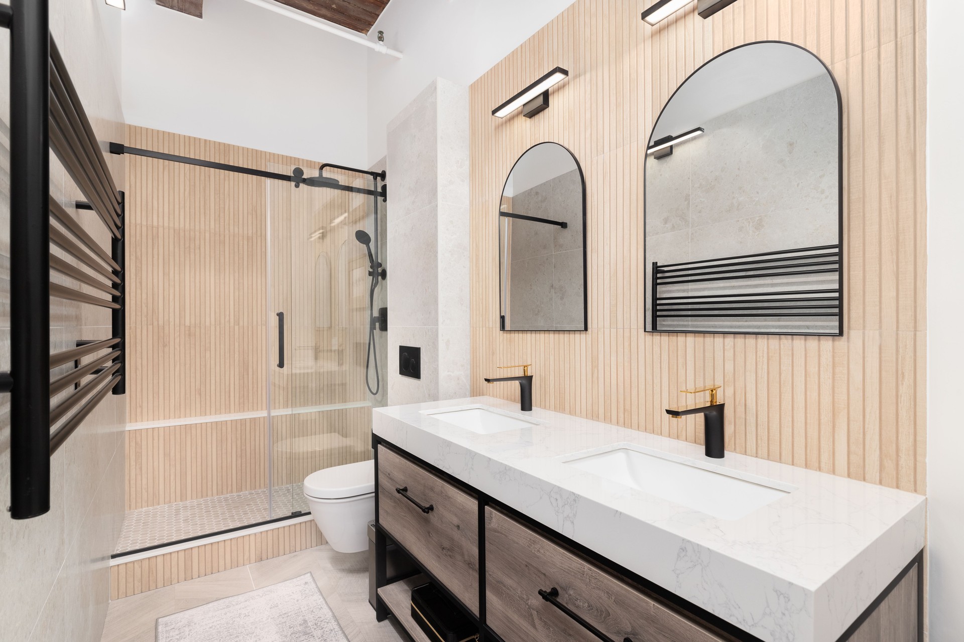 A bathroom with wood slat paneling accent and a wood tiled shower.